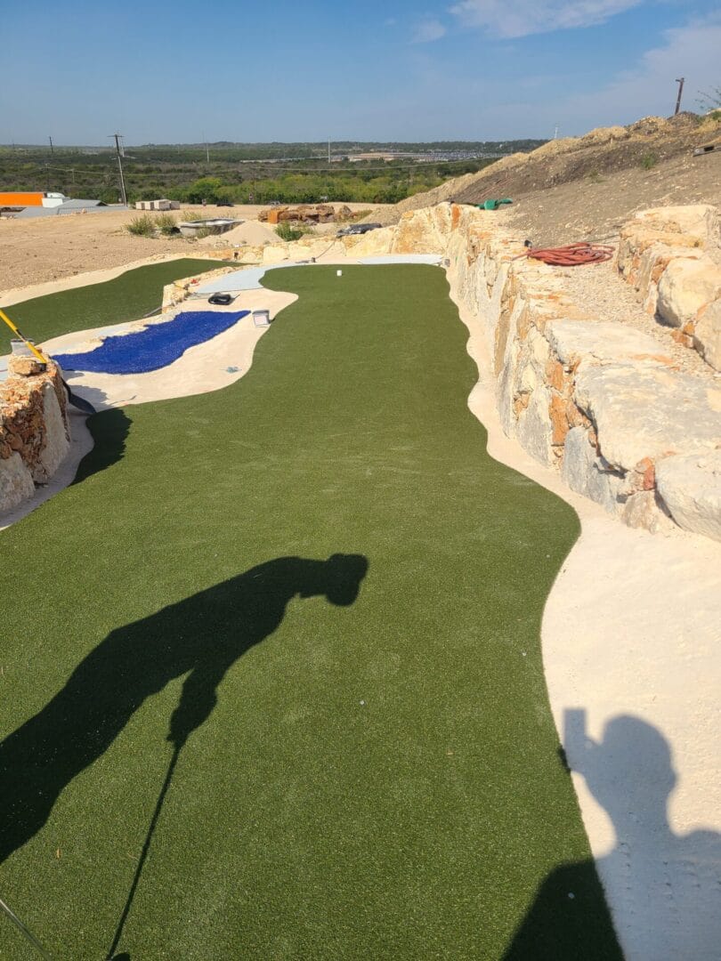 Unfinished putting lane and water feature liner during construction