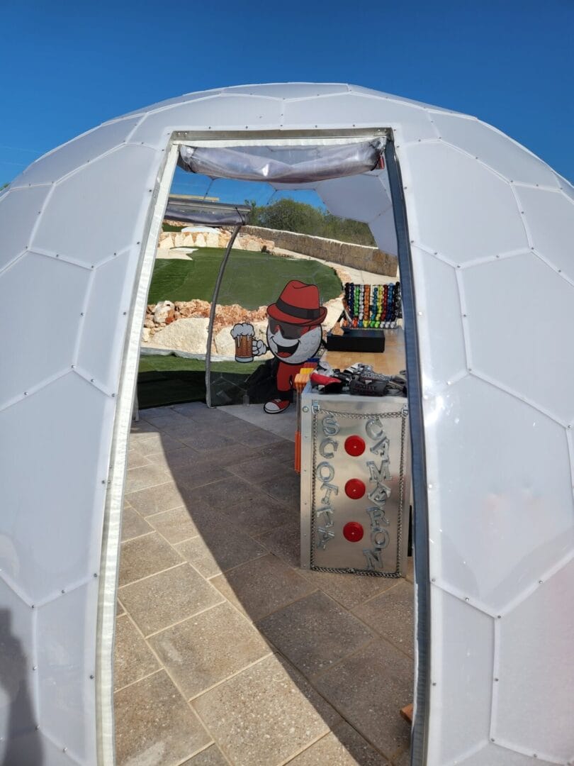 Dome doorway framing the mascot cutout and putter display inside the clubhouse